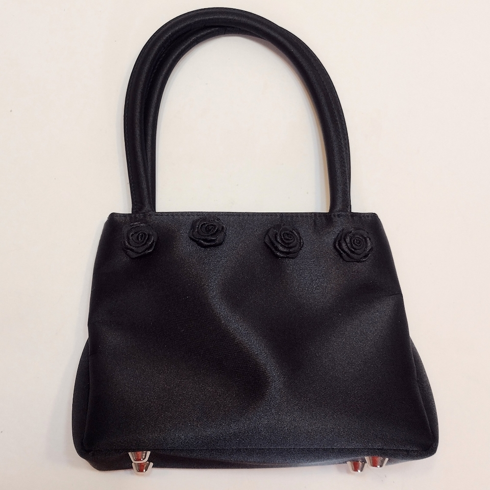 Kenneth Cole black satin-look mini purse accented with rosettes.